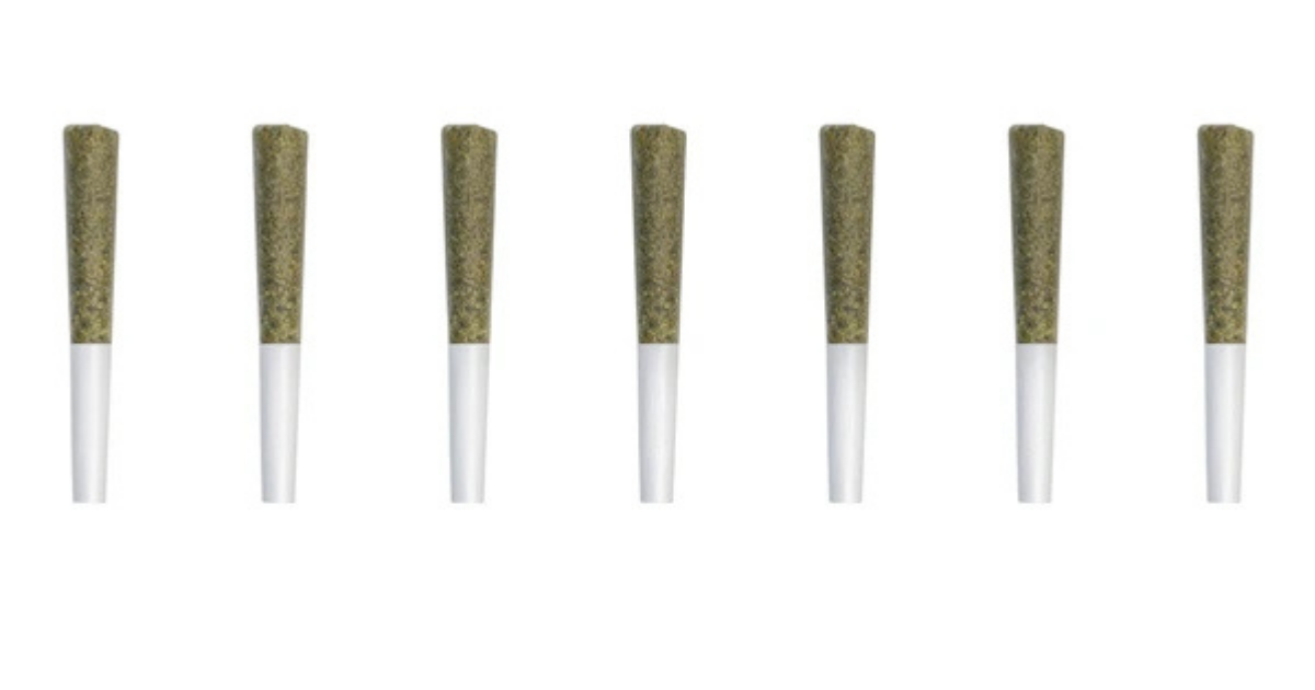 A curated setup of rolling accessories including a grinder, tray, tips, and cone loader arranged neatly for joint prep.