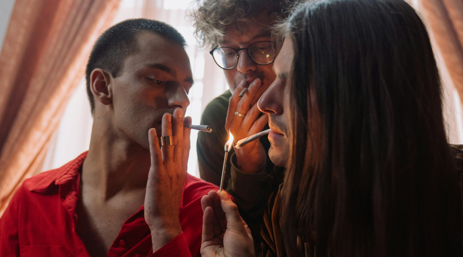 Close-up of people smoking a blunt with tobacco-free wrap they used in joint rolling.
